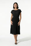 Black FJØRNA women's pleated A-line midi dress with round neck, casual style, perfect for everyday wear.