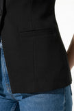 Black women's sleeveless fitted waistcoat by FJØRNA with button front, perfect for summer outfits.