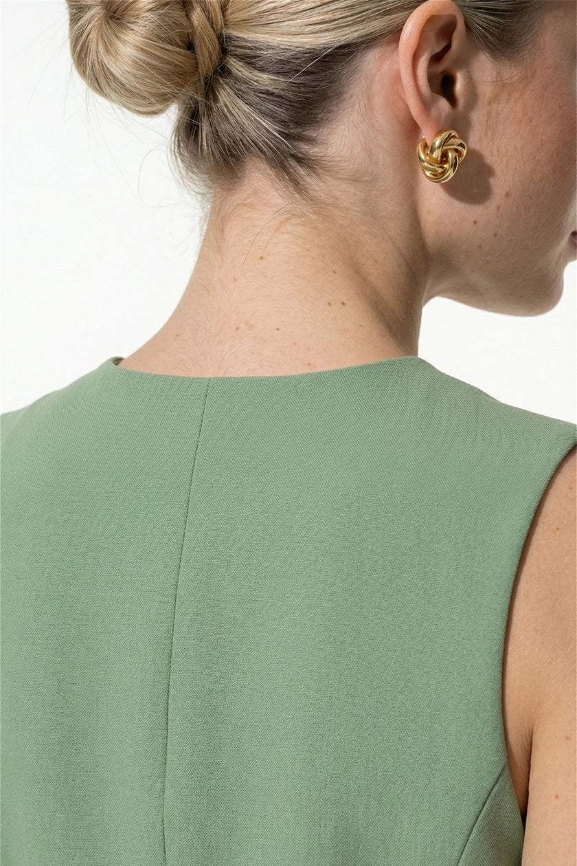 Green women's sleeveless fitted waistcoat by FJØRNA with button front, perfect for summer styling.