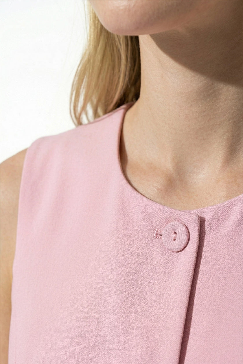 Pink sleeveless women's waistcoat by FJØRNA featuring a fitted design and button front, perfect for summer outfits.