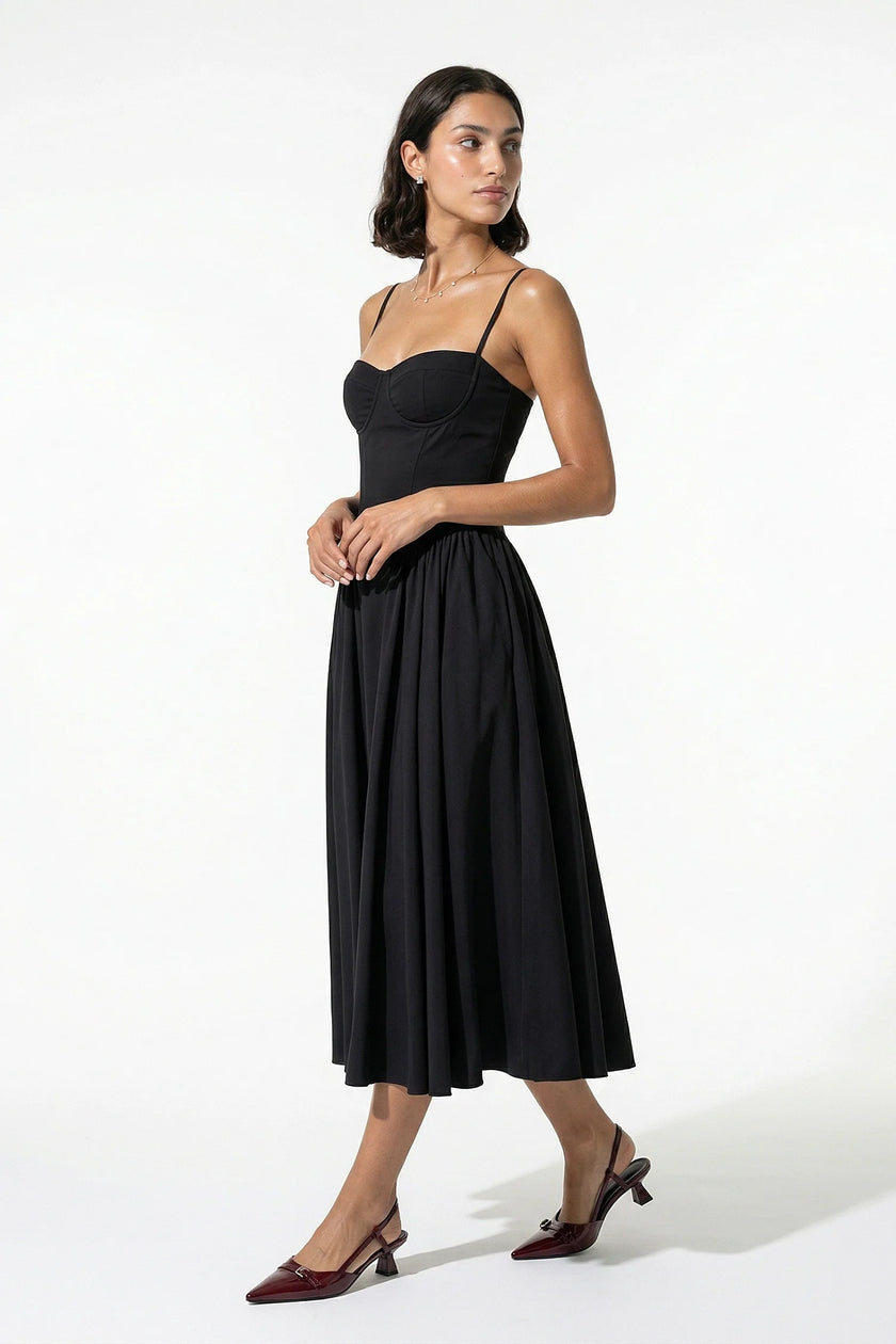 Black FJØRNA backless sleeveless pleated midi dress for women, shown from full body with halter neckline and elegant design.