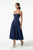 Deep blue FJØRNA backless sleeveless midi dress with pleats, halter neckline, and flowing skirt, full body view.