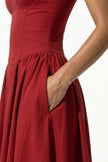 Red sleeveless backless midi dress for women by FJØRNA featuring pleated design and halter neckline, shown in close-up detail.