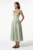 FJØRNA backless sleeveless midi dress for women in sage green with pleated halter design, full-body view.