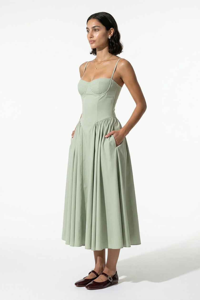 FJØRNA backless sleeveless midi dress for women in sage green with pleated halter design, full-body view.