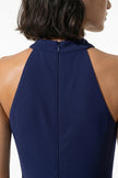 Navy blue FJØRNA sleeveless maxi dress for women with high neck, A-line silhouette, and side slit, displayed in macro shot.
