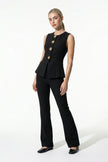 Black women's sleeveless waistcoat by FJØRNA with tailored fit and metal button details, shown from full body view.
