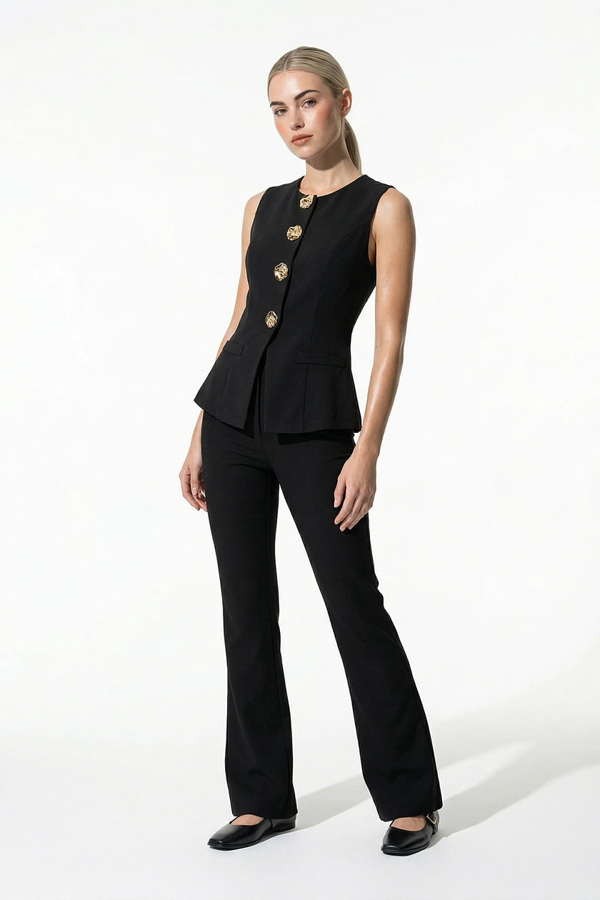 Black women's sleeveless waistcoat by FJØRNA with tailored fit and metal button details, shown from full body view.