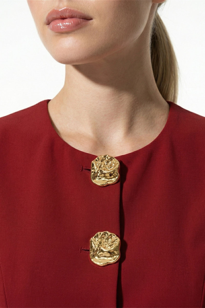 Women's sleeveless waistcoat by FJØRNA with metal buttons, deep red color, tailored fit, and detailed front design.