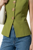 Olive green women's sleeveless waistcoat by FJØRNA with tailored fit and metal button details, shown in close-up detail shot.