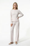 White women's slim fit co-ord set by FJØRNA featuring long sleeve top and wide-leg trousers, full-body view.