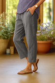 FJØRNA women's lightweight summer trousers with straight leg design, breathable fabric, and front pockets, ideal for warm weather.
