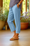 FJØRNA lightweight summer women's trousers with straight legs, breathable fabric, and front pockets, ideal for warm weather.