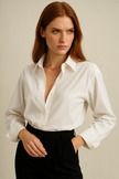 Light blue FJØRNA cotton blouse for women, featuring a relaxed fit with ruffled sleeves and a stylish, breathable design.