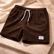 Men's corduroy shorts by FJØRNA with drawstring waist, showcasing casual style and textured fabric on a neutral background.