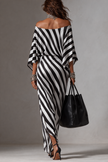 FJØRNA Statement Monochrome Stripe Asymmetric Maxi Dress in white, featuring bold stripe pattern and flowing silhouette.