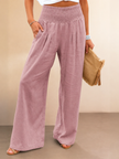 FJØRNA linen summer women's trousers with high waist, wide leg, and drawstring, shown in natural fabric and relaxed fit style.