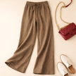 FJØRNA lightweight summer women's trousers with relaxed fit, drawstring waist, and side pockets, ideal for warm weather.