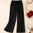FJØRNA women's lightweight summer trousers with relaxed fit, drawstring waist, and side pockets, ideal for casual warm-weather wear.