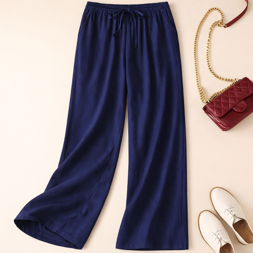 FJØRNA lightweight women's summer trousers with relaxed fit, drawstring waist, and pocket details, perfect for warm weather.