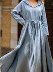 FJØRNA cotton linen boho hooded dress with relaxed fit, perfect for casual occasions or weddings, in soft neutral tones.