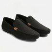 Black men's canvas slip-on loafers by FJØRNA with a sleek, casual design on a clean background.