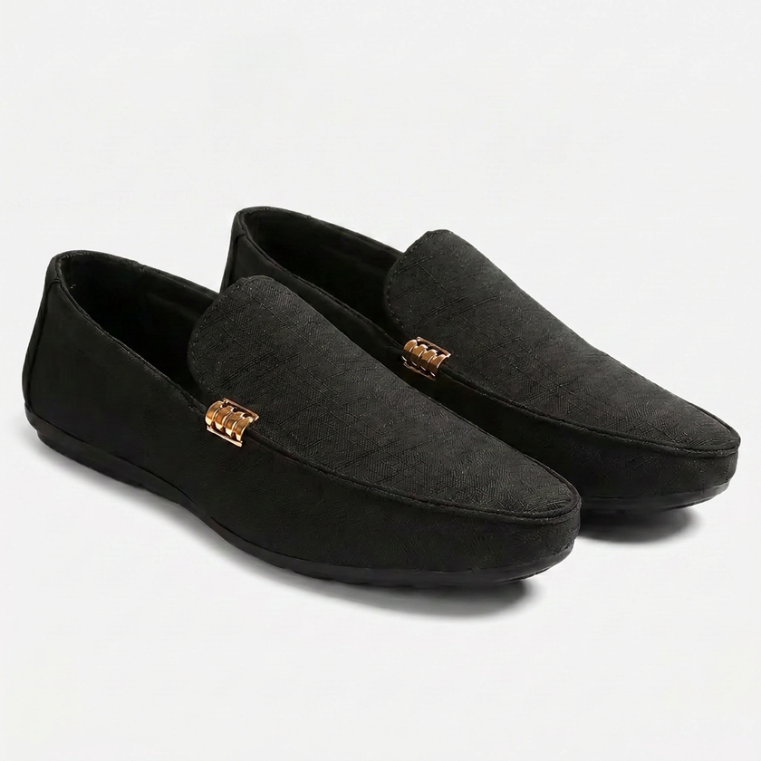 Black men's canvas slip-on loafers by FJØRNA with a sleek, casual design on a clean background.
