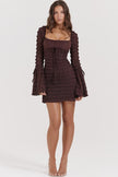 FJØRNA coffee-colored ruched mini dress displayed on a hanger with a fitted silhouette and textured fabric.