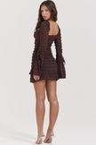 FJØRNA coffee-colored ruched mini dress displayed on a hanger, showcasing its fitted design and textured fabric.