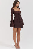 FJØRNA coffee-colored ruched mini dress shown on a model, featuring a fitted silhouette and stylish design.
