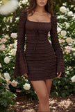 FJØRNA coffee-colored ruched mini dress displayed on a hanger, showing its fitted silhouette and textured fabric.