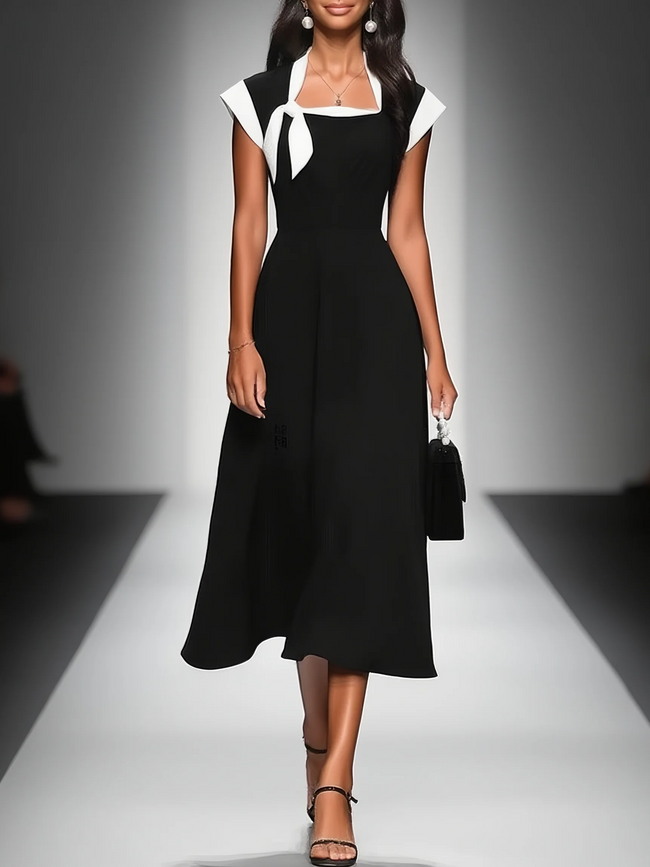 FJØRNA colorblock midi dress for women featuring a vibrant multi-tone design and a flowing, elegant silhouette.