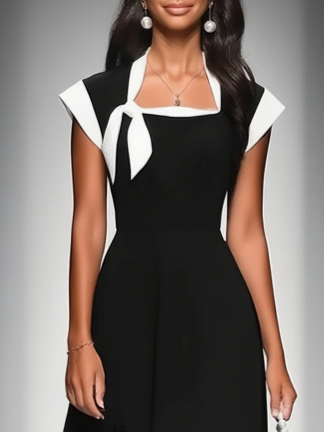 FJØRNA colorblock midi dress for women featuring a stylish, multi-colored design and a flowing, midi-length silhouette.