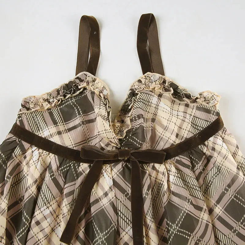 FJØRNA Coquette plaid mini dress featuring a fitted silhouette and stylish plaid pattern, perfect for casual or semi-formal wear.