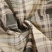 FJØRNA Coquette plaid mini dress with long sleeves, fitted bodice, and flared skirt in red and black checkered pattern.