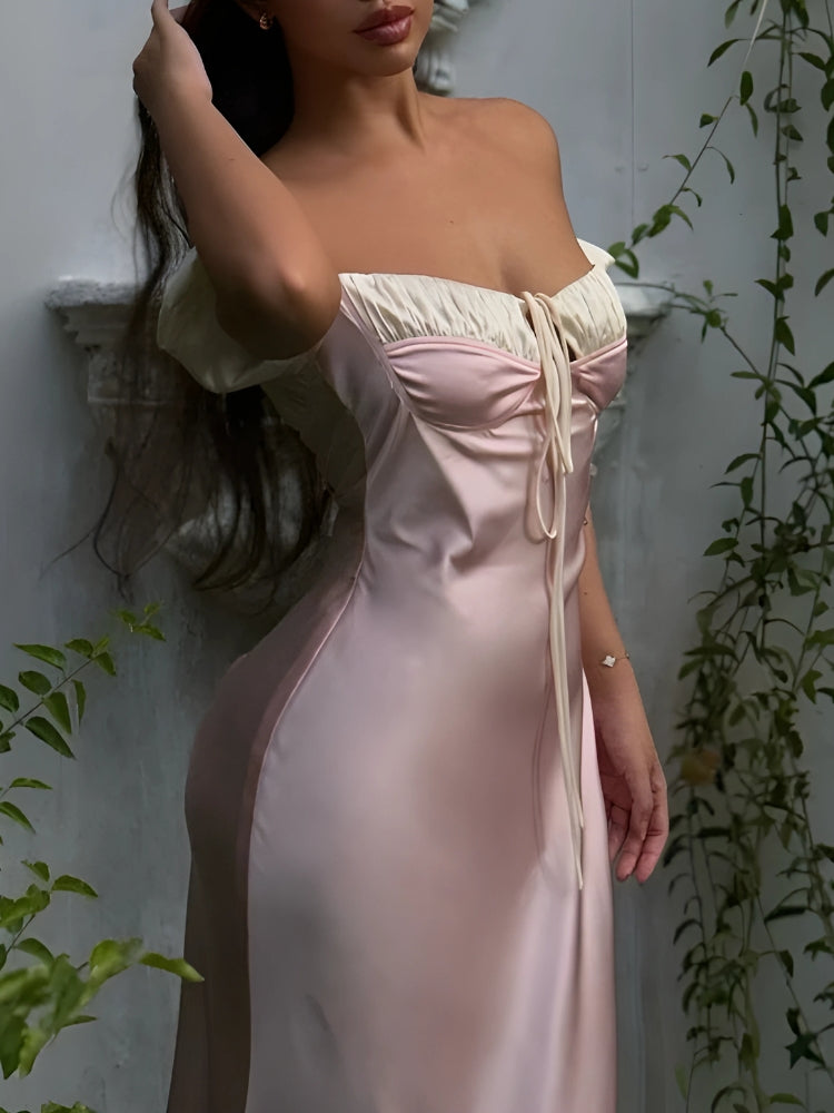 FJØRNA Coquette Princess satin maxi dress displayed on a hanger, featuring a flowing design and elegant neckline.