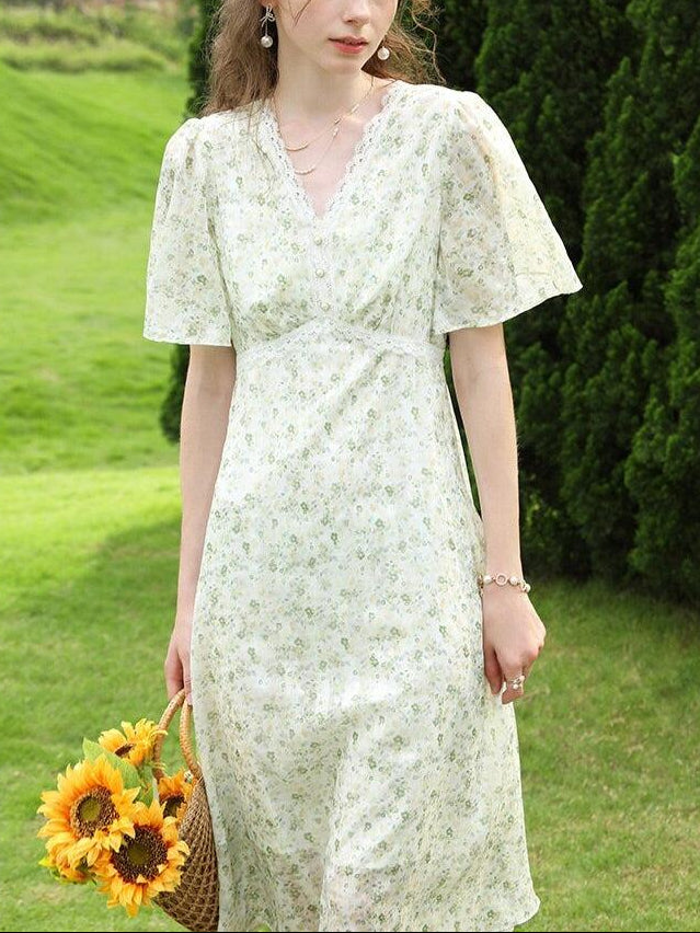 White cottagecore floral midi dress by FJØRNA featuring a flowy silhouette and delicate floral pattern.