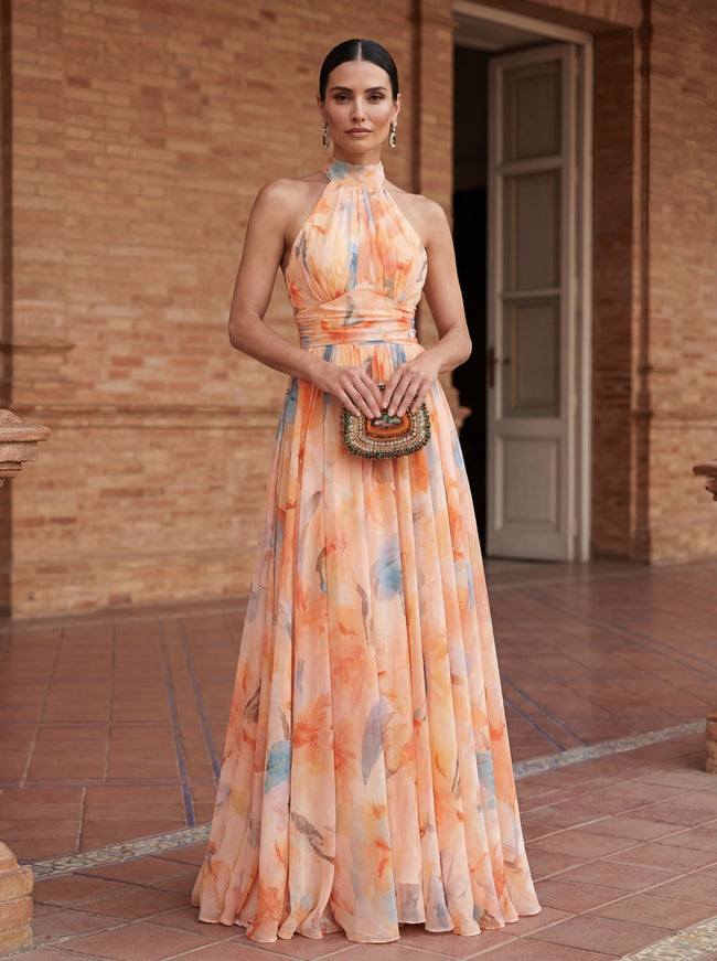 Elegant FJØRNA women's maxi dress with a printed halter neck design, flowing fabric, and stylish silhouette.