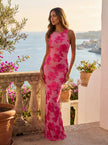 Floral sleeveless elegant maxi dress for women by FJØRNA, featuring a flowing design and vibrant floral pattern.