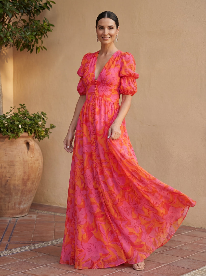 Elegant V-neck maxi dress for women by FJØRNA, flowing fabric with movement, perfect for evening wear and special occasions.