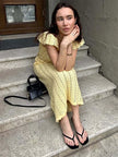 FJØRNA crochet midi dress with intricate knit pattern, sleeveless design, and flowy silhouette perfect for summer wear.