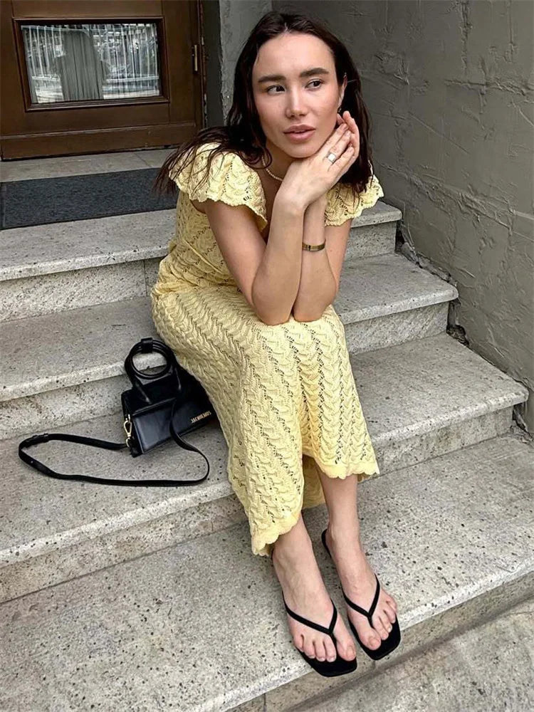 FJØRNA crochet midi dress with intricate knit pattern, sleeveless design, and flowy silhouette perfect for summer wear.