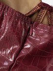 FJØRNA crocodile print women's mini dress, stylish for party and day wear, shown on a model in a vibrant, fitted dress.