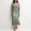 FJØRNA relaxed V-neck knit top and satin maxi skirt set in cyan, featuring a cozy knit top and flowing satin skirt.