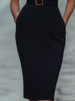 FJØRNA black sleeveless sheath dress with belt, mandarin collar, and fitted silhouette, perfect for elegant women’s fashion.