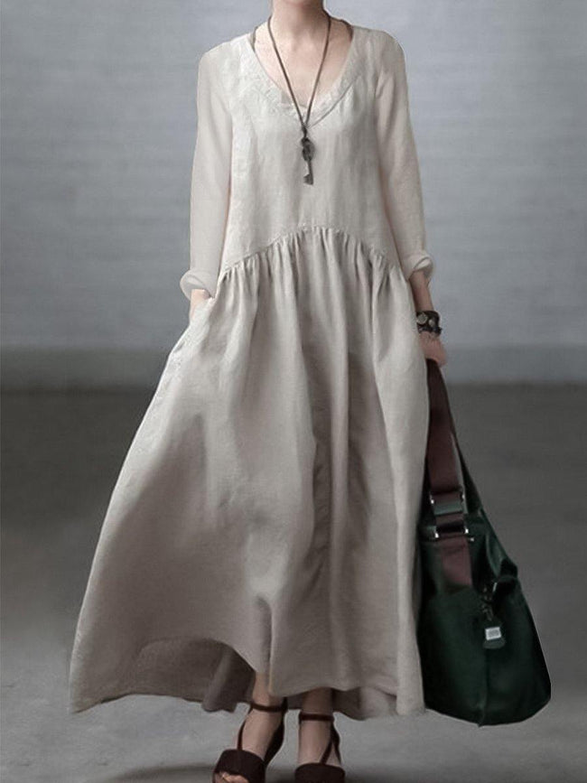 Light-colored loose V-neck cotton and linen dress by FJØRNA, casual wedding dress with flowing fabric and relaxed fit.