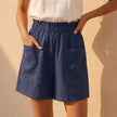 Dark blue women's linen summer shorts with pockets from FJØRNA, featuring a relaxed fit and casual style.
