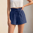 Dark blue FJØRNA women's linen summer shorts with ruffle detail, lightweight and casual for warm weather.