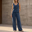 Dark blue FJØRNA relaxed sleeveless two-piece set with decorative buttons and wide-leg trousers, displayed on a model.