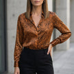 Dark brown print long sleeve summer blouse for women by FJØRNA, featuring a stylish design and comfortable fit.